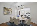 Bright dining area featuring a modern table, stylish chairs, and an open floor plan at 1098 Berganot Trl, Castle Pines, CO 80108