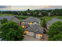 Charming home with a two-car garage, stone accents, and well-maintained landscaping at 1098 Berganot Trl, Castle Pines, CO 80108