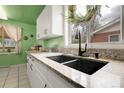 Close-up of kitchen sink featuring granite counters and modern black fixtures at 4108 S Inca St, Englewood, CO 80110