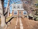 Two-story home with brick accents, siding, and a pathway leading to the front door at 1050 S Lewiston Way, Aurora, CO 80017