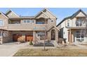 Charming two-story home featuring a stone facade, covered porch, and a two-car garage with wooden doors at 3613 Silverton St, Boulder, CO 80301