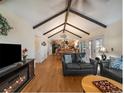 Inviting open-concept living room with hardwood floors, vaulted ceiling, and natural light at 10624 W Berry Pl, Littleton, CO 80127