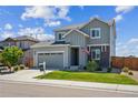 Beautifully landscaped two-story home featuring a two-car garage and a welcoming front yard at 6954 E 117Th Ave, Thornton, CO 80233