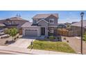 Attractive two-story home with a two-car garage, landscaping, and a well-maintained front lawn at 6954 E 117Th Ave, Thornton, CO 80233