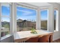 Sunlit breakfast nook with a large window, hardwood floors, and seating for four at 4464 E 139Th Ave, Thornton, CO 80602