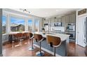 Modern kitchen with stainless steel appliances, quartz countertops, and a breakfast bar at 4464 E 139Th Ave, Thornton, CO 80602