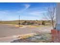 Street view showcasing a well-maintained neighborhood with green spaces, landscaping, and a peaceful environment at 4464 E 139Th Ave, Thornton, CO 80602