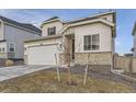 Charming home with stone accents, two-car garage, well-maintained lawn, and inviting front entrance at 13362 Amber Sky St, Parker, CO 80134