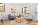 Inviting living space with comfortable armchair, modern table and sofa with lots of natural light at 1715 Grove St, Denver, CO 80204