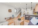 Living area featuring open floor plan, kitchen island, staircase, and stylish furniture at 1715 Grove St, Denver, CO 80204