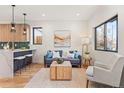 Cozy living area with a stylish couch, wooden coffee table, and plenty of natural light from the window at 1715 Grove St, Denver, CO 80204
