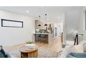 Open-concept living area with a modern kitchen, hardwood floors, and stylish decor for easy living at 1715 Grove St, Denver, CO 80204