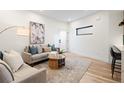 Well-lit living area with hardwood floors, neutral tones, and a cozy seating arrangement at 1715 Grove St, Denver, CO 80204