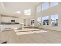 Spacious living room featuring tall windows, hardwood floors, and an open floor plan at 39856 Floyd St, Elizabeth, CO 80107