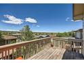 Outdoor deck featuring serene views of the surrounding neighborhood, mature trees, and distant mountains at 10528 Applebrook Cir, Highlands Ranch, CO 80130