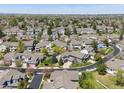 Expansive aerial view of a residential neighborhood filled with lush trees and well-maintained homes at 13804 W 61St Cir, Arvada, CO 80004