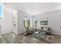 Inviting living room with hardwood floors, neutral colors, and ample natural light from the large windows at 1998 S Poplar Ct, Denver, CO 80224