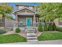 Charming two-story home with a welcoming front porch and beautifully landscaped front yard at 4578 Quandary Peak St, Brighton, CO 80601