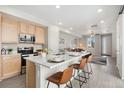 Stylish kitchen with white countertops, stainless steel appliances, and an island with barstool seating at 17068 E Center Pl, Aurora, CO 80017