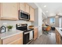 Well-equipped kitchen featuring stainless steel appliances and an island with seating, and open layout at 17068 E Center Pl, Aurora, CO 80017