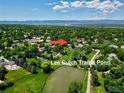 An aerial view of the property's serene location near Lee Gulch Trail and Pond and with mountain views at 7019 S Windermere St, Littleton, CO 80120