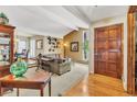 Inviting living room with beamed ceilings, hardwood floors, large windows, and elegant furnishings at 7019 S Windermere St, Littleton, CO 80120