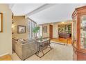 Bright living room with beam ceilings, large windows, and a view into a home office space at 7019 S Windermere St, Littleton, CO 80120