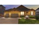 Charming two-story home with a well-maintained lawn and a two-car garage at 3995 Manorbrier Cir, Castle Rock, CO 80104