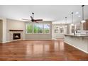 Spacious living room boasts a fireplace, hardwood floors, and large windows with views to the outside at 3995 Manorbrier Cir, Castle Rock, CO 80104