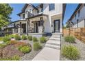 Lovely modern home features a stone porch with steps and beautiful landscaping in the front yard at 2525 S Pearl St, Denver, CO 80210