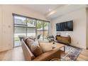 Modern living room featuring a comfortable couch, large windows, and hardwood flooring at 2525 S Pearl St, Denver, CO 80210