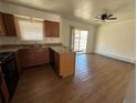Kitchen featuring wooden cabinets, stone countertops, and stainless steel appliances at 3577 S Ouray Cir, Aurora, CO 80013