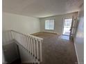 Bright living room featuring carpeted flooring and a door to the outside at 3577 S Ouray Cir, Aurora, CO 80013