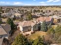 Beautiful aerial view of the backyard with a patio area and lush greenery within a residential community at 21548 E Ottawa Cir, Aurora, CO 80016