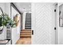 Stylish hallway with wood floors, decorative accents, and view of modern staircase at 3926 Kalamath St, Denver, CO 80211