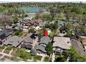 Aerial view of a house with solar panels, mature landscaping, and a lake in the background at 726 S Corona St, Denver, CO 80209