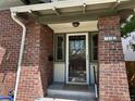 Close-up of the home's front porch, showcasing brick detail, address numbers and inviting glass door at 726 S Corona St, Denver, CO 80209