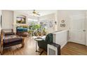 Bright living room with hardwood floors, many plants, and a decorative fireplace at 12421 Irving Dr, Broomfield, CO 80020