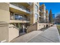 Welcoming condo building entrance with a nicely landscaped walkway at 180 Cook St # 105, Denver, CO 80206