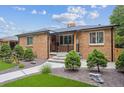 A well-kept lawn, neat landscaping, and a brick exterior give this home great curb appeal at 2664 Forest St, Denver, CO 80207