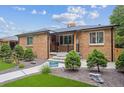Beautiful brick home boasting manicured landscaping, a well-maintained lawn, and an inviting entrance at 2664 Forest St, Denver, CO 80207