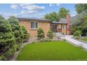 Well-maintained brick house with a green lawn and trimmed landscaping, offering great curb appeal at 2664 Forest St, Denver, CO 80207