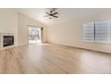 Bright living room with modern flooring, a fireplace, and a sliding glass door to the outside at 20344 Heather Ln, Parker, CO 80138