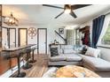 Inviting living room with comfortable seating, wood flooring, and staircase at 2700 S Holly St # 202, Denver, CO 80222