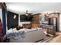 Cozy living room showcasing a black brick fireplace and stylish kitchen in the background at 2700 S Holly St # 202, Denver, CO 80222