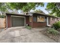 This brick home features an attached garage and manicured landscaping around the front yard at 632 Wyoming St, Golden, CO 80403