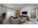 Inviting living room featuring a cozy fireplace, balcony access, and comfortable seating area at 14495 E 1St Dr # C1, Aurora, CO 80011