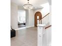 Inviting foyer with hardwood floors, chandelier, and arched doorway at 295 Jersey St, Denver, CO 80220