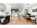 Bright dining area with modern chandelier, wood floors, and view of the kitchen at 9161 W Lake Dr, Littleton, CO 80123