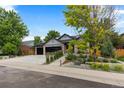 Beautiful house exterior with a two-car garage and well-manicured front yard at 9161 W Lake Dr, Littleton, CO 80123